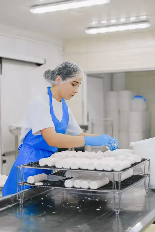 A food production worker in protective clothing at a processing facility